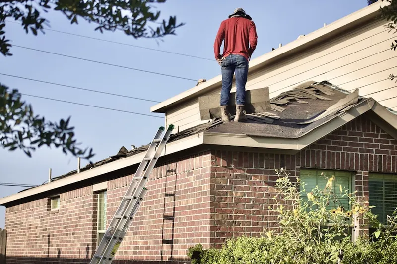 Professional roofer working on a residential roof in Jamesburg Gardens